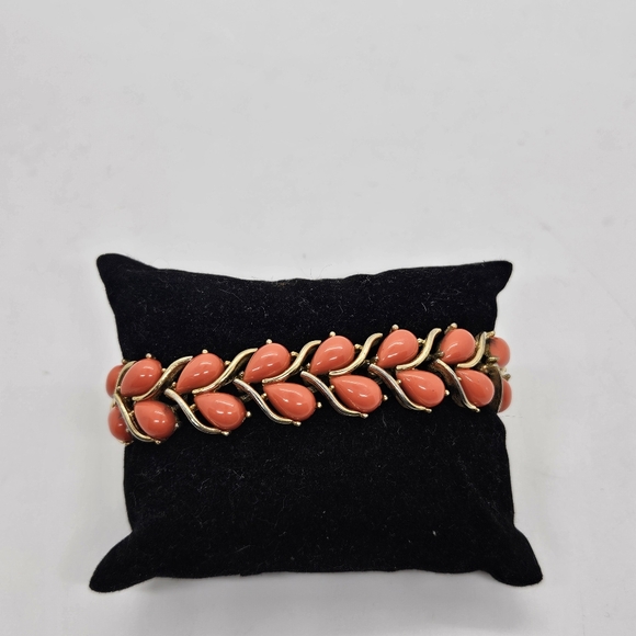 Trifari Jewelry - vintage Trifari gold tone and coral colored bracelet